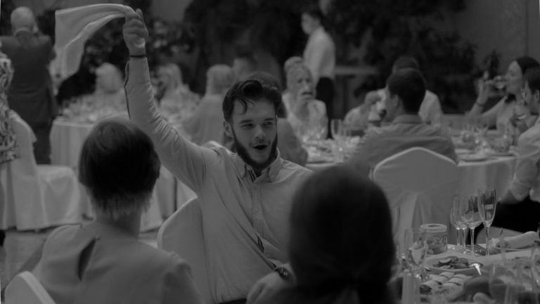 A lively moment captured during a formal dinner event with people celebrating and enjoying the occasion.